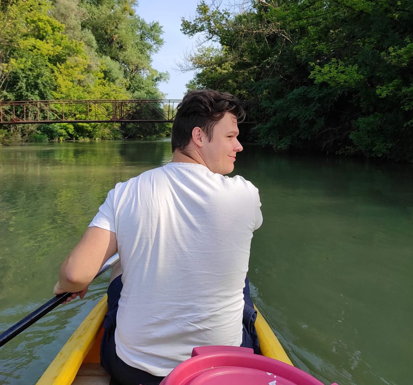 Radek in a canoe going down the river.